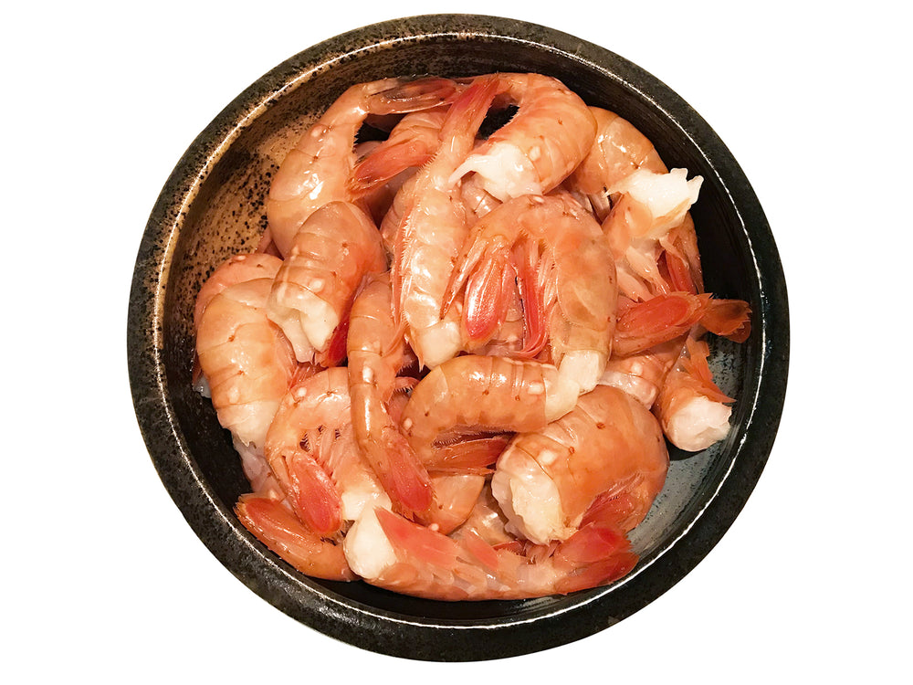 A bowl cooked Alaskan Spot Prawns with heads removed.